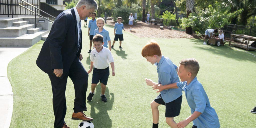 Headmaster Seivold playing soccer with Lower Division students